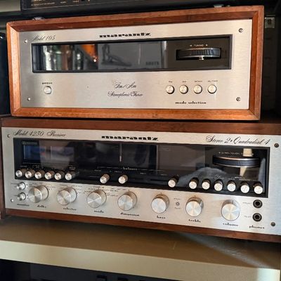 Sale Photo Thumbnail #81: Vintage Marantz stereo audio components including a Model 105 FM/AM tuner stacked on a Model 4230 Quadradial 4 receiver, both housed in wooden cabinets.