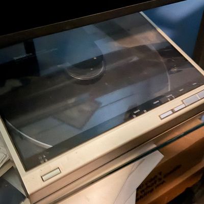 Sale Photo Thumbnail #133: Technics linear tracking automatic turntable resting on a glass shelf, circa 1980s.
