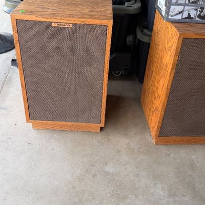 Sale Photo Thumbnail #140: Pair of vintage Klipsch floor speakers with oak wood cabinets and brown woven fabric grilles.