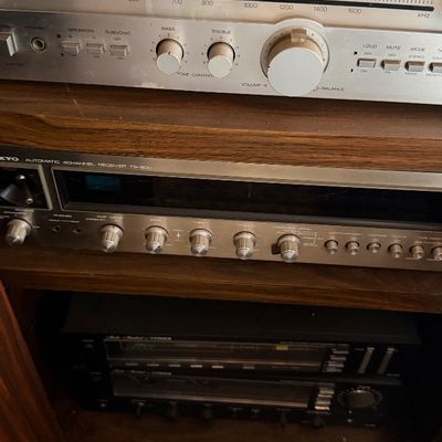 Sale Photo Thumbnail #141: Vintage Scott 335R AM/FM stereo receiver shown above an Onkyo 4-channel receiver in a wooden cabinet.