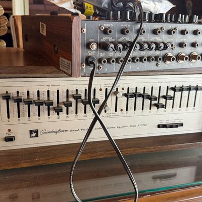 Sale Photo Thumbnail #146: Vintage Soundcraftsmen Model RP2212 audio frequency equalizer in a wood cabinet, stacked beneath a multi-channel audio interface unit.