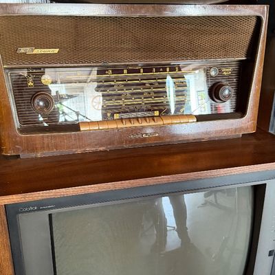 Sale Photo Thumbnail #159: Vintage Grundig Majestic tabletop radio sitting atop a vintage RCA Colortrak CRT television set.
