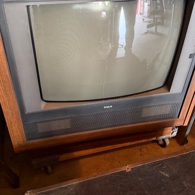 Sale Photo Thumbnail #163: Vintage RCA ColorTrak stereo monitor television set in a woodgrain cabinet, circa 1980s.