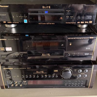 Sale Photo Thumbnail #172: Stack of vintage Pioneer Elite audio/video components including a DVD player and receiver, featuring classic black faceplates and gold-tone lettering.