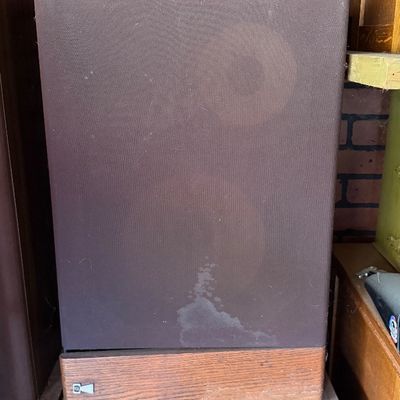 Sale Photo Thumbnail #178: Vintage JBL floor speaker featuring a wooden base trim and brown cloth grille showing light staining and wear.