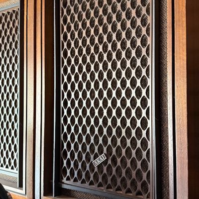 Sale Photo Thumbnail #179: Vintage Akai wooden speaker cabinets featuring decorative geometric latticework grilles and fabric mesh background.