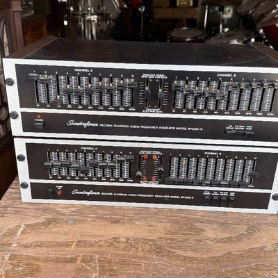 Sale Photo Thumbnail #181: Stack of two vintage Soundcraftsmen record-playback audio frequency equalizers, including models RP2201-R and RP2215-R, featuring black faceplates with silver trim and dual-channel slide controls.