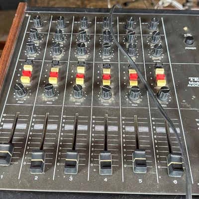 Sale Photo Thumbnail #183: Vintage TEAC Model 2A 6-channel audio mixer with wood side panels, showing light surface dust from age and use.