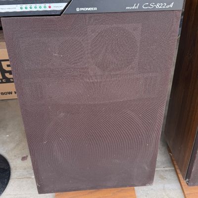 Sale Photo Thumbnail #186: Vintage Pioneer CS-822A floor-standing speaker with a wood grain cabinet, brown mesh grille, and top-mounted power level indicator.