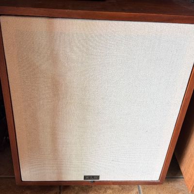 Sale Photo Thumbnail #188: Vintage KLH speaker in a walnut cabinet with a beige woven cloth grille, circa late 1960s to 1970s.