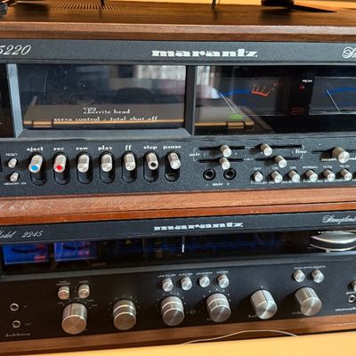 Sale Photo Thumbnail #192: Vintage Marantz Model 5220 cassette deck stacked on a Marantz Model 2245 stereophonic receiver, both featuring wood cases and silver-face controls from the 1970s.