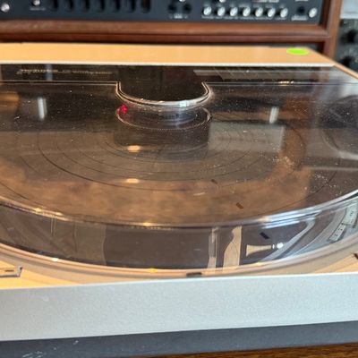 Sale Photo Thumbnail #194: Vintage Technics SL-10 direct-drive linear-tracking turntable featuring a silver metallic chassis and a clear acrylic dust cover.