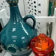 Sale Photo Thumbnail #5: Teal glazed ceramic decanter with handle alongside a small amber-orange pressed glass candy dish with lid.