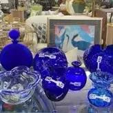 Sale Photo Thumbnail #27: Collection of vibrant cobalt blue glass art pieces, including vases, bottles, and decorative bowls in various mid-century to modern shapes.