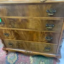 Sale Photo Thumbnail #31: Traditional mahogany four-drawer dresser featuring flame mahogany veneer, shell carvings, and ornate brass bail handles.