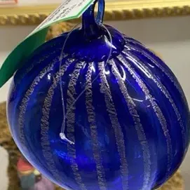Sale Photo Thumbnail #33: Hand-blown cobalt blue glass ornament featuring textured vertical silver accents and a top hanging loop.