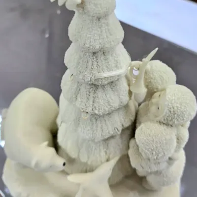 Sale Photo Thumbnail #84: Department 56 Snowbabies figurine featuring children decorating a snowy tree alongside a polar bear.