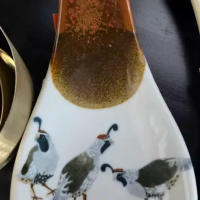 Sale Photo Thumbnail #87: Vintage glazed ceramic spoon rest featuring a hand-painted quail motif with brown drip-glaze accents.