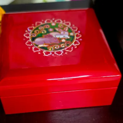 Sale Photo Thumbnail #99: Glossy red lacquer trinket box featuring a mother-of-pearl inlay medallion of two rabbits on the lid.