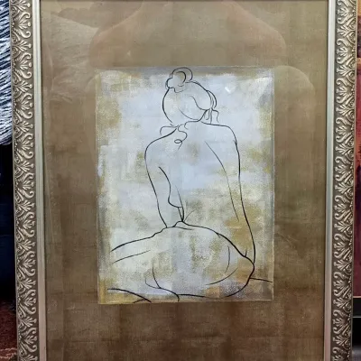 Sale Photo Thumbnail #126: Framed contemporary minimalist line drawing of a seated female nude figure, presented with a wide tan mat in a silver ornate molded frame.