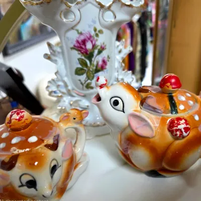 Sale Photo Thumbnail #160: Vintage ceramic deer creamer and sugar bowl set with mushroom accents alongside a reticulated floral porcelain vase.