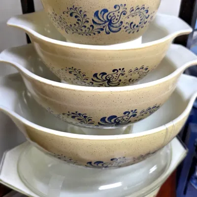 Sale Photo Thumbnail #177: Vintage Pyrex Homestead pattern Cinderella mixing bowl set, featuring beige speckled glass with blue floral scrollwork.
