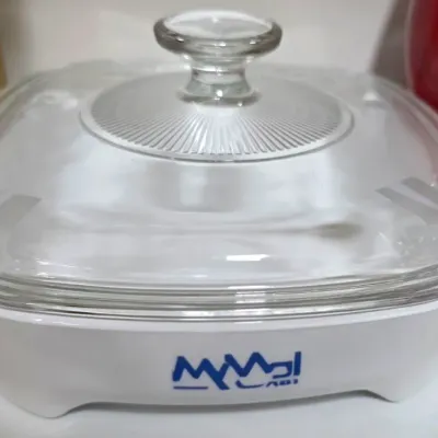 Sale Photo Thumbnail #195: Vintage white Corning Ware square casserole dish featuring a printed logo and fitted clear glass lid.