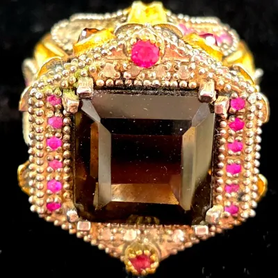 Sale Photo Thumbnail #284: Ornate vintage statement ring featuring a large emerald-cut dark smoky quartz stone surrounded by beaded filigree and small pink accent stones.