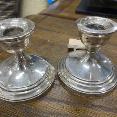 Sale Photo Thumbnail #297: Pair of vintage weighted sterling silver short candlesticks showing light surface tarnish and wear.