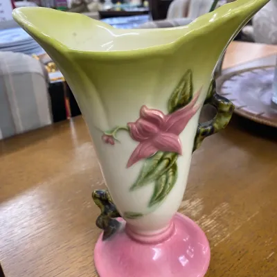 Sale Photo Thumbnail #332: Vintage Hull Art Pottery Fuchsia pattern vase, featuring embossed pink floral motifs, green foliage, a flared rim, and a pink pedestal base.