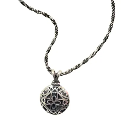 Sale Photo Thumbnail #339: Silver-tone filigree locket or poison pendant featuring an intricate quatrefoil motif, paired with a twisted rope chain.