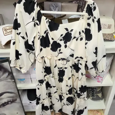 Sale Photo Thumbnail #363: Off-white and black floral print mini dress with three-quarter length puff sleeves and a ruffled tiered skirt.