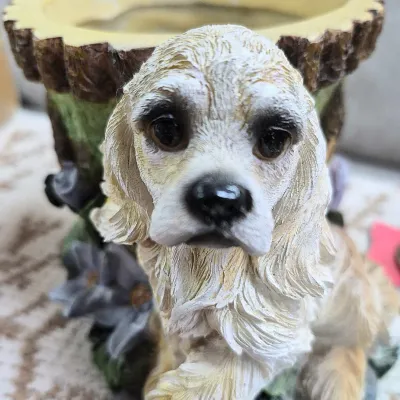 Sale Photo Thumbnail #383: Decorative resin Cocker Spaniel planter featuring a faux tree stump pot base and detailed fur texturing.
