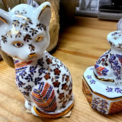 Sale Photo Thumbnail #451: Royal Crown Derby porcelain cat figurine and matching trinket box featuring an ornate Imari-style floral pattern with gold accents.