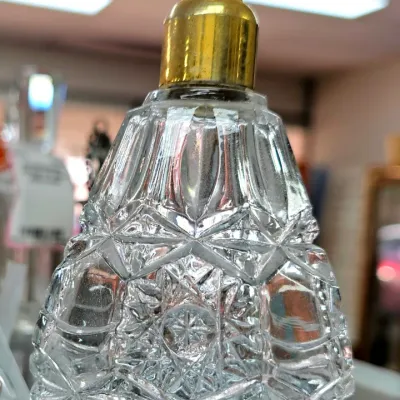 Sale Photo Thumbnail #462: Vintage cut crystal perfume atomizer bottle featuring geometric and starburst patterns with a brass metal top.