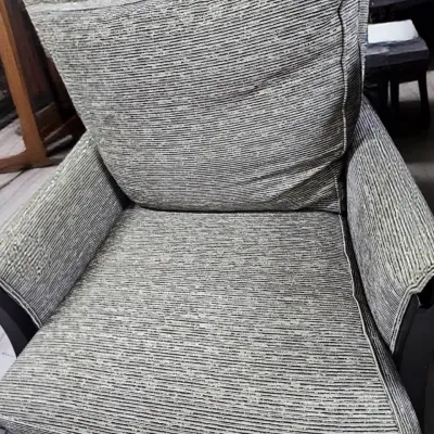 Sale Photo Thumbnail #481: Contemporary upholstered armchair featuring a textured, grey and white striped ribbed fabric and dark wooden frame accents.