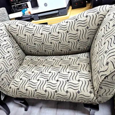 Sale Photo Thumbnail #482: Contemporary patterned chaise lounge or bench, featuring curved armrests and a beige upholstery with a black geometric wave pattern.