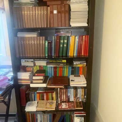 Sale Photo Thumbnail #35: Dark wood five-shelf bookcase completely filled with various hardcovers, paperbacks, and reference books.