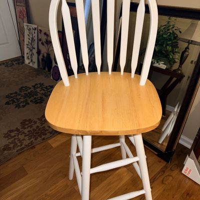 Sale Photo Thumbnail #45: Two-tone wooden swivel barstool with a natural wood seat, white painted frame, and spindle backrest.