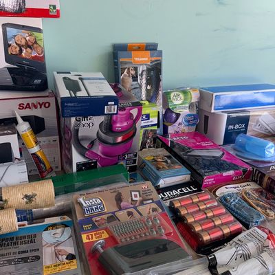 Sale Photo Thumbnail #89: Assortment of packaged household goods, including electronics, weather stripping, an Insta Hang tool, Duracell batteries, and dog accessories.