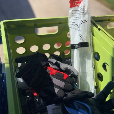 Sale Photo Thumbnail #93: Lime green plastic crate filled with utility items, including work gloves, Duck Tape, and a packaged Rubbermaid support brace.