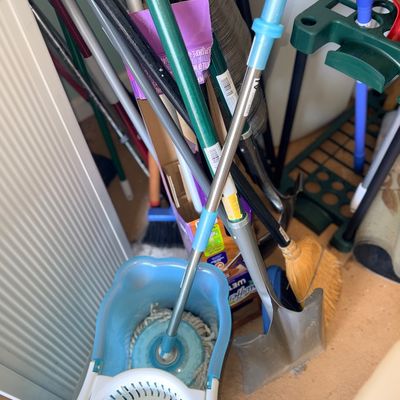 Sale Photo Thumbnail #108: Collection of assorted household cleaning supplies and yard tools, including a spin mop with bucket, shovels, and brooms.