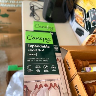 Sale Photo Thumbnail #110: Boxed Canopy expandable closet rods in bronze finish, new in original packaging.