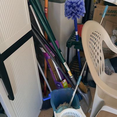 Sale Photo Thumbnail #183: Collection of household cleaning tools and yard implements, including a spin mop bucket system, brooms, a duster, and a shovel.