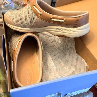 Sale Photo Thumbnail #192: Pair of Easy Spirit slip-on mule sneakers featuring tan leather trim, woven fabric vamps, and boat-shoe inspired lace detailing, presented in their original box.