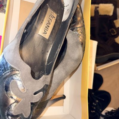 Sale Photo Thumbnail #197: Pair of vintage Stefania high-heeled pumps featuring grey suede trim and snakeskin-patterned leather detail, presented in their original shoe box with visible wear on the insoles.