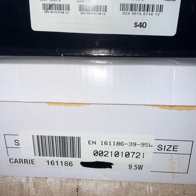 Sale Photo Thumbnail #232: Stacked shoe boxes showing size labels for JCPenney Glinda sandals in black size 10 M and Carrie style shoes in size 9.5W.