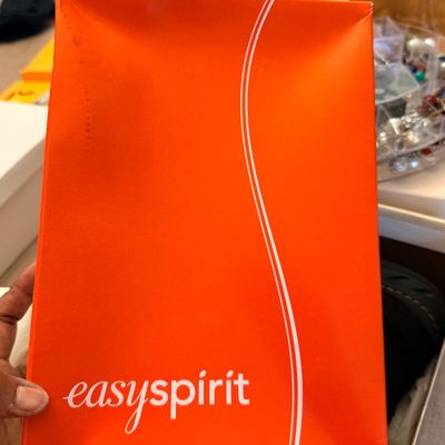 Sale Photo Thumbnail #234: Bright orange Easy Spirit shoebox lid held in hand.