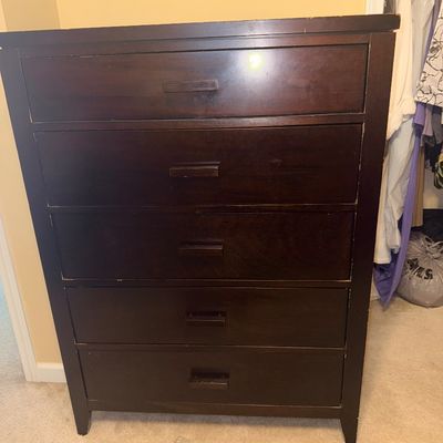 Sale Photo Thumbnail #270: Dark espresso wooden five-drawer chest of drawers with matching wooden handles. Shows light surface wear along the top edges.