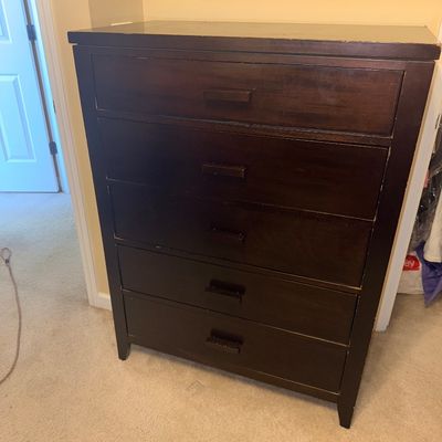 Sale Photo Thumbnail #271: Contemporary dark brown wood five-drawer chest of drawers with matching wooden bar pulls.
